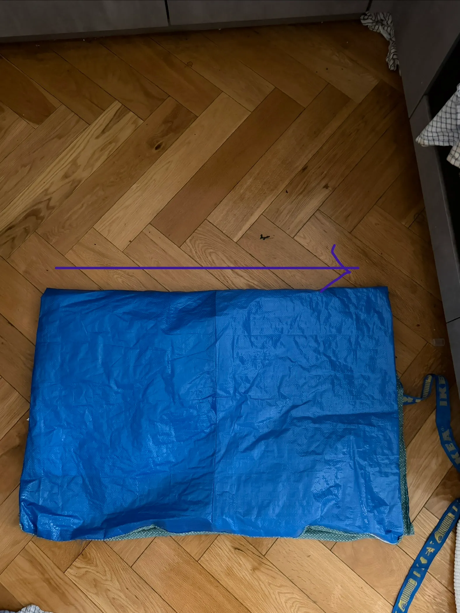top view of the panel folded in half lengthwise with an arrow pointing right