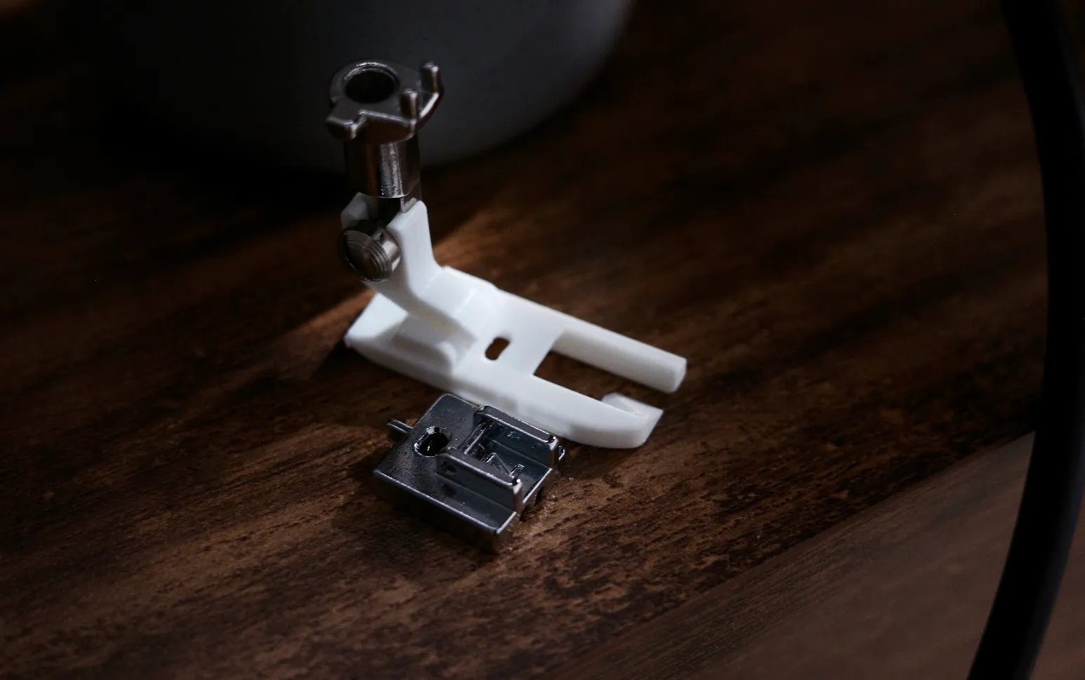 flat foot on a wooden table next to invisible zipper foot
