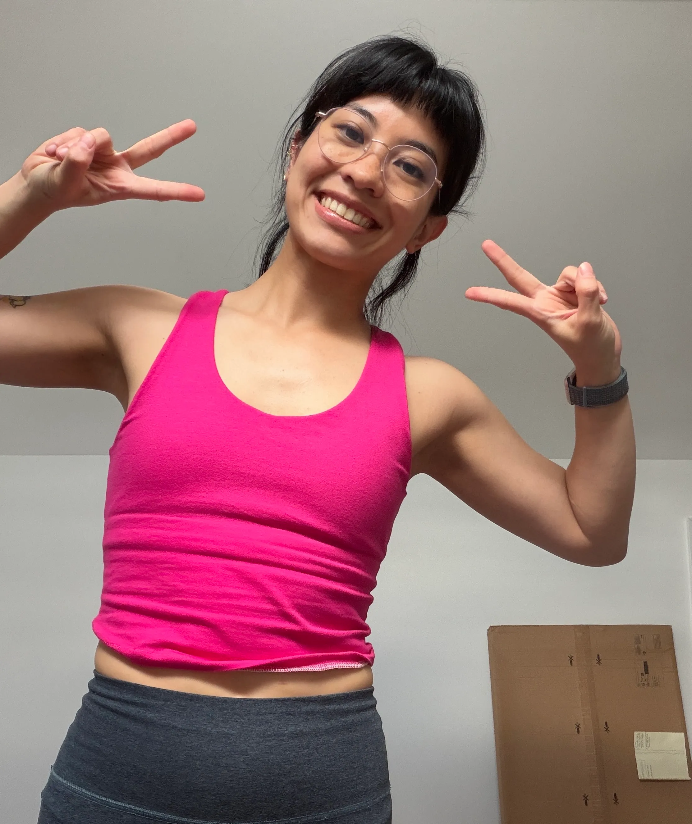 Photo of celina doing the peace sign and smiling with brami on