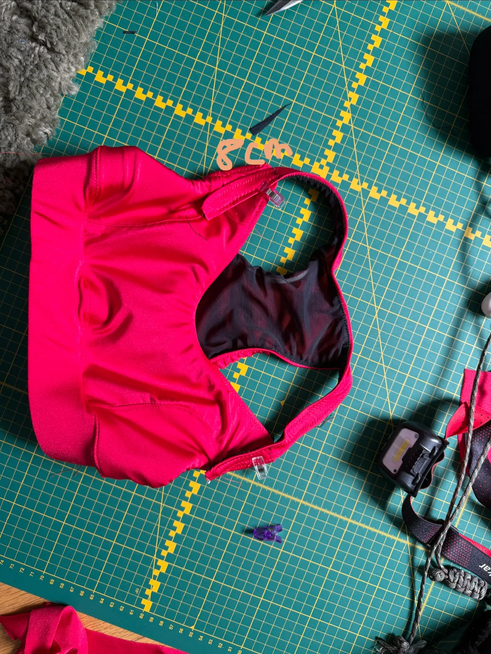 The red side of the finished bra, racerback opening showing the black interior
