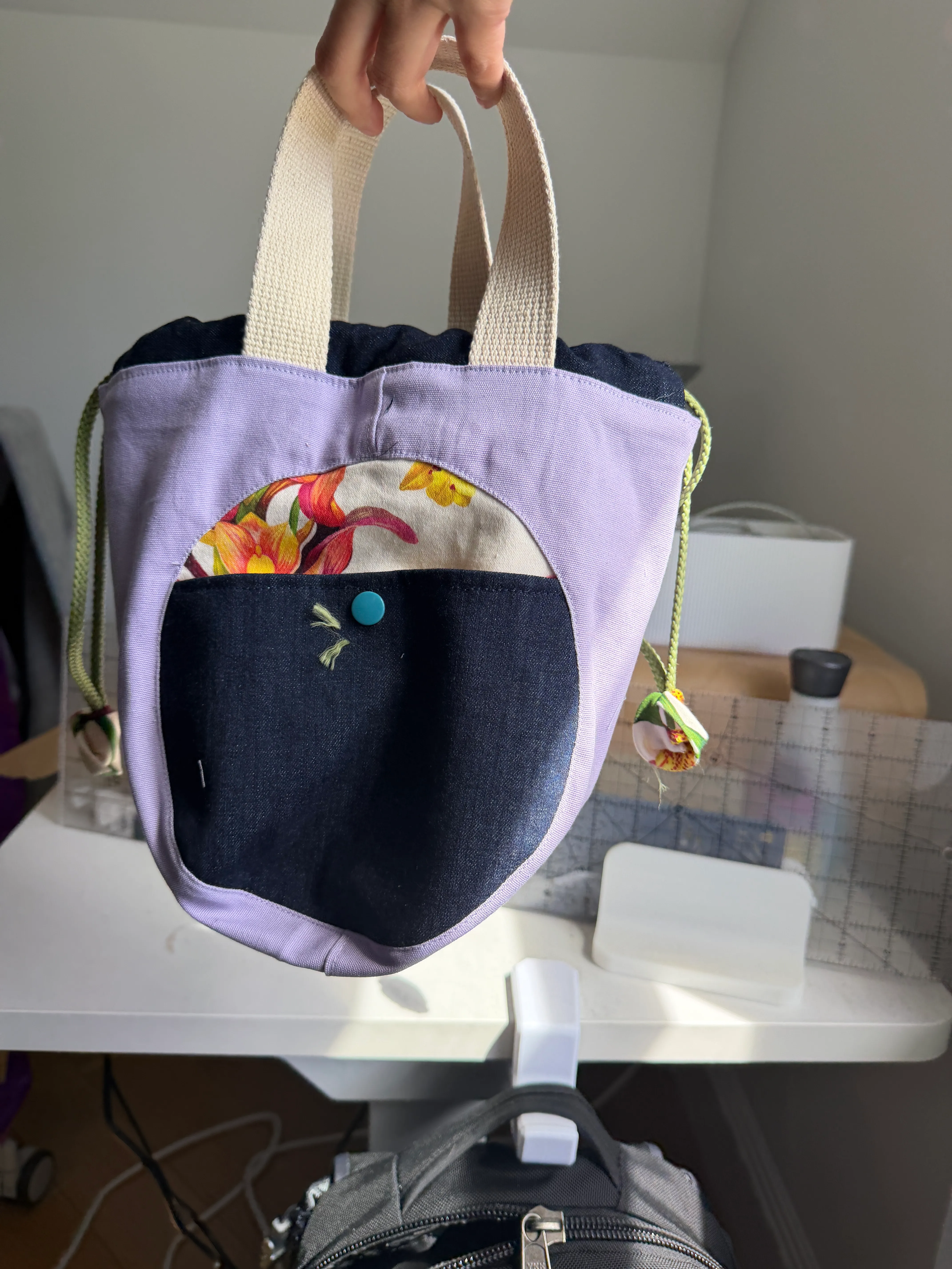 close up photo of the encircle pouch viewed from the denim pattern side of the bag
